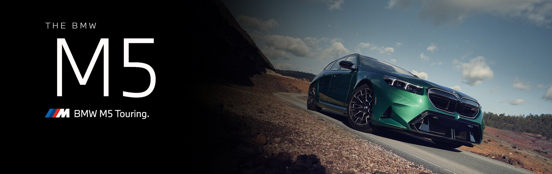 The new BMW M5 Touring in green driving down desert road | BMW of Lynnwood in Lynnwood WA