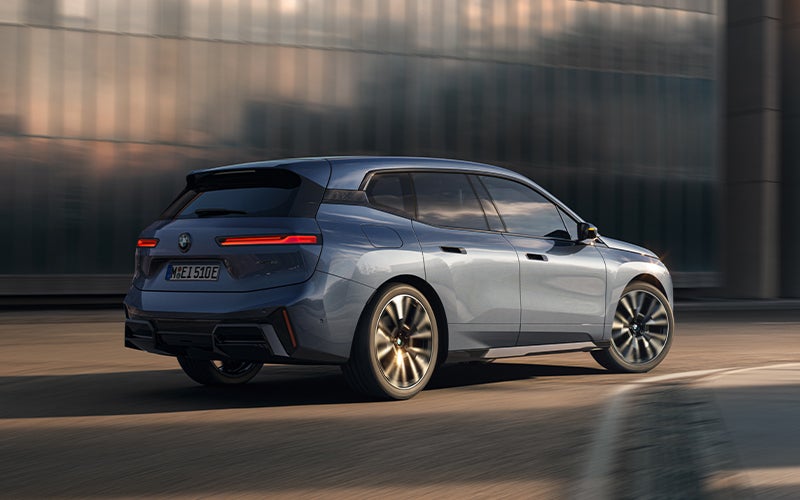 The BMW iX driving with the front wheel turned. | BMW of Lynnwood in Lynnwood WA